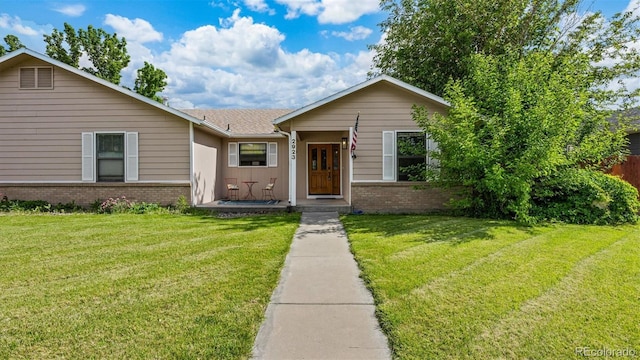 2923 Bonito Ave, Grand Junction, CO 81504 - view of front of home featuring brick siding and a front lawn