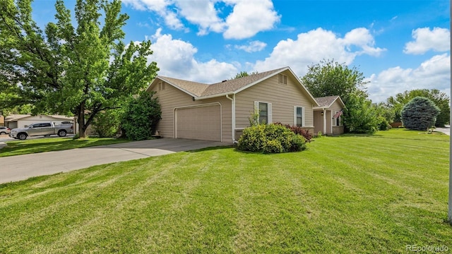 2923 Bonito Ave, Grand Junction, CO 81504 - view of home's exterior featuring a garage, concrete driveway, and a lawn