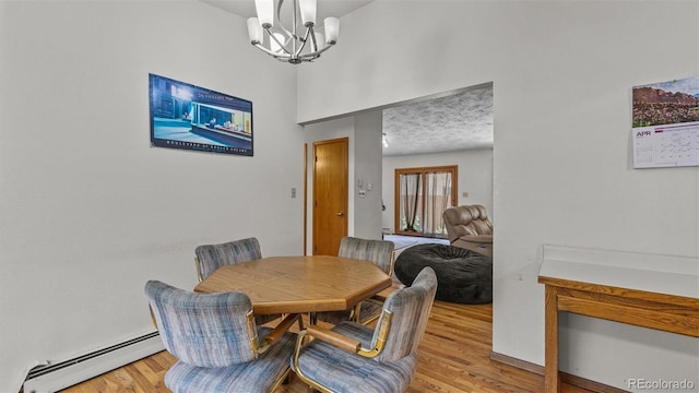 2923 Bonito Ave, Grand Junction, CO 81504 - dining area with baseboard heating, a chandelier, and light wood-type flooring