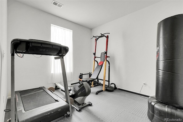 workout area featuring baseboards and visible vents