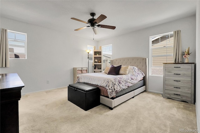 bedroom with baseboards, light carpet, and a ceiling fan