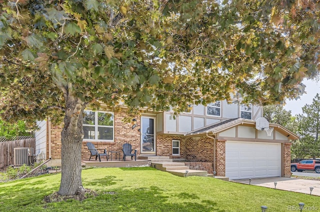 16602 E Gunnison Pl, Aurora, CO 80017 - obstructed view of property featuring brick siding, concrete driveway, and cooling unit