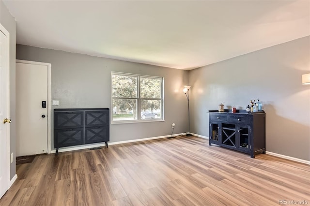 16602 E Gunnison Pl, Aurora, CO 80017 - unfurnished living room with wood finished floors and baseboards