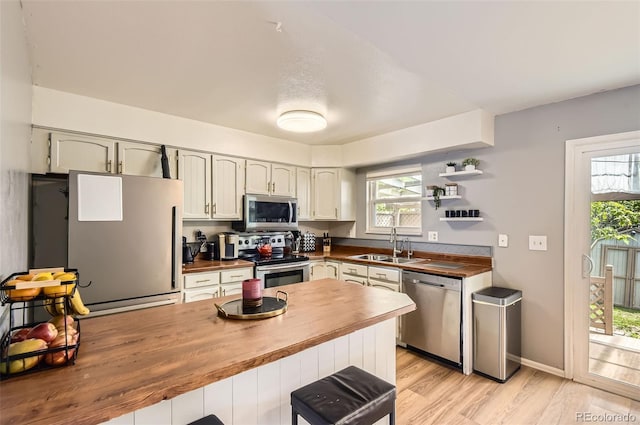 16602 E Gunnison Pl, Aurora, CO 80017 - kitchen featuring stainless steel appliances, butcher block counters, a sink, and plenty of natural light