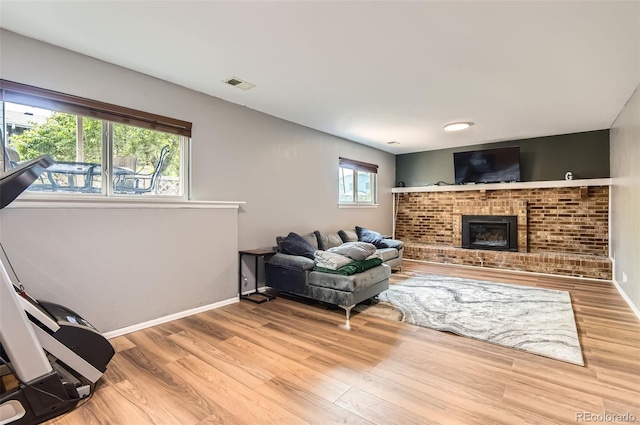 16602 E Gunnison Pl, Aurora, CO 80017 - living area featuring wood finished floors, baseboards, and a brick fireplace