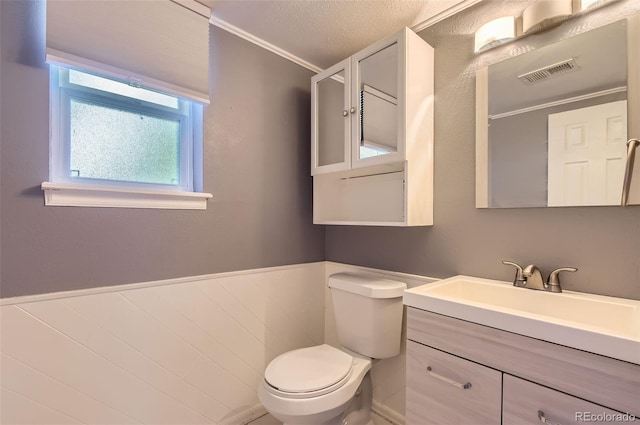 16602 E Gunnison Pl, Aurora, CO 80017 - bathroom with toilet, vanity, ornamental molding, and a textured ceiling