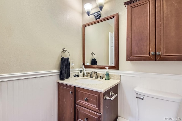 16602 E Gunnison Pl, Aurora, CO 80017 - half bath with a wainscoted wall, vanity, and toilet