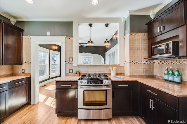 kitchen featuring dark brown cabinets, appliances with stainless steel finishes, and light wood-style floors