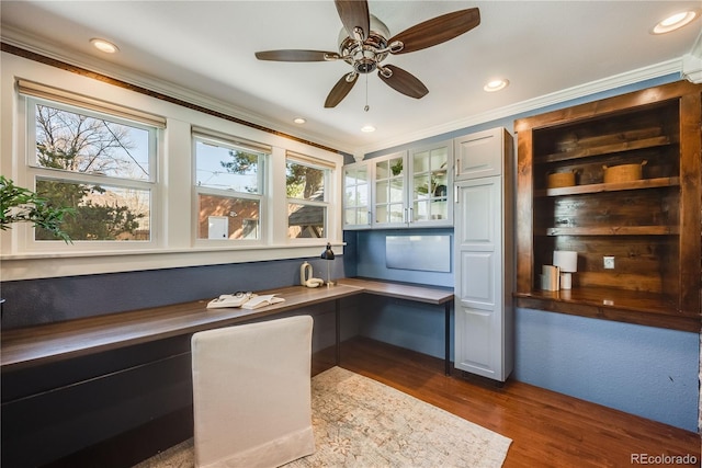 home office featuring crown molding, recessed lighting, dark wood-style floors, and built in desk