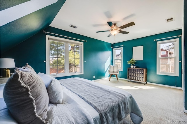 carpeted bedroom with visible vents, multiple windows, and baseboards