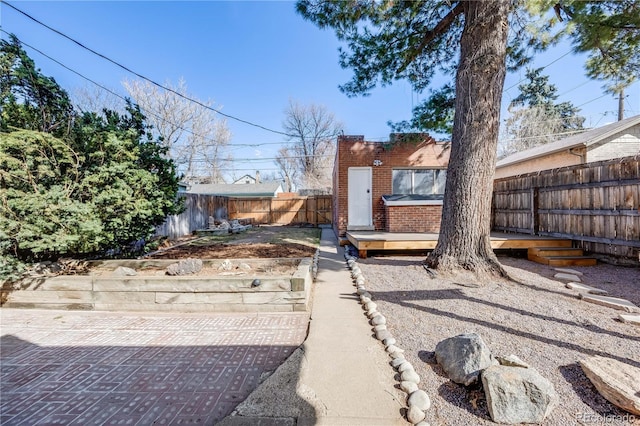 view of yard featuring a fenced backyard and a wooden deck