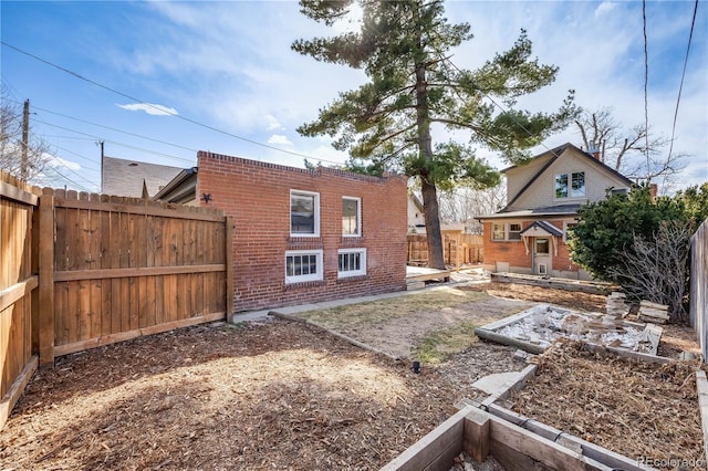 view of yard featuring a vegetable garden and a fenced backyard