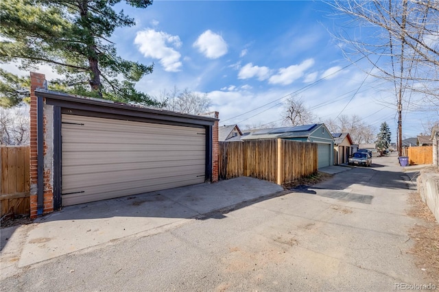 detached garage featuring fence