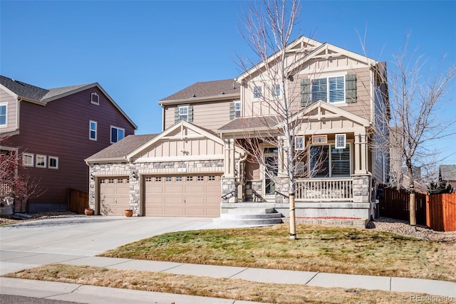 craftsman house featuring a porch, a garage, fence, concrete driveway, and board and batten siding