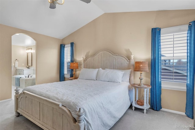30 Stewart Way, Erie, CO 80516 - carpeted bedroom featuring multiple windows, vaulted ceiling, baseboards, and arched walkways