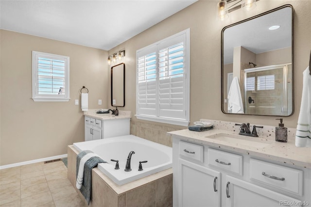 30 Stewart Way, Erie, CO 80516 - bathroom featuring a sink, tile patterned floors, a stall shower, two vanities, and a garden tub
