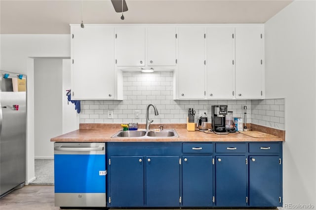 3118 E San Miguel St, Colorado Springs, CO 80909 - kitchen featuring dishwashing machine, stainless steel fridge, a sink, light wood-style floors, and decorative backsplash