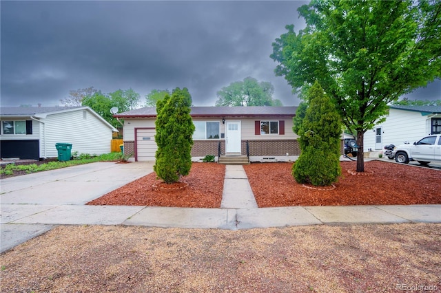 3118 E San Miguel St, Colorado Springs, CO 80909 - view of front facade featuring brick siding, a garage, and driveway