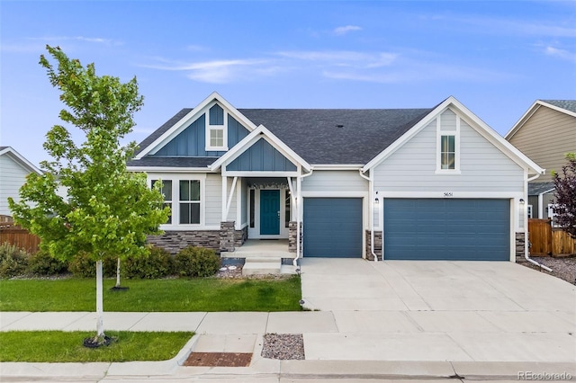 5651 Gore Creek Pl, Brighton, CO 80601 - craftsman-style house with concrete driveway, board and batten siding, stone siding, and a garage