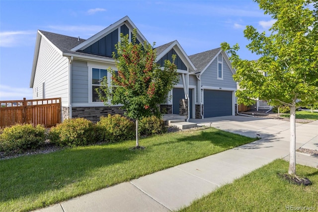 5651 Gore Creek Pl, Brighton, CO 80601 - craftsman house with board and batten siding, driveway, stone siding, and a shingled roof