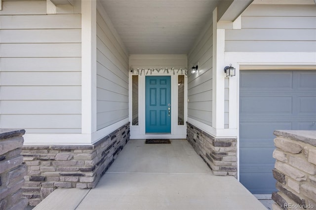 5651 Gore Creek Pl, Brighton, CO 80601 - view of exterior entry with a garage and stone siding
