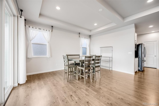 5651 Gore Creek Pl, Brighton, CO 80601 - dining area with light wood-type flooring, recessed lighting, and a raised ceiling