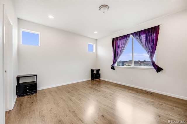 5651 Gore Creek Pl, Brighton, CO 80601 - unfurnished room featuring plenty of natural light, wood finished floors, and recessed lighting