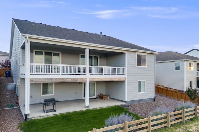 5651 Gore Creek Pl, Brighton, CO 80601 - back of house with a balcony, a fenced backyard, and a patio area