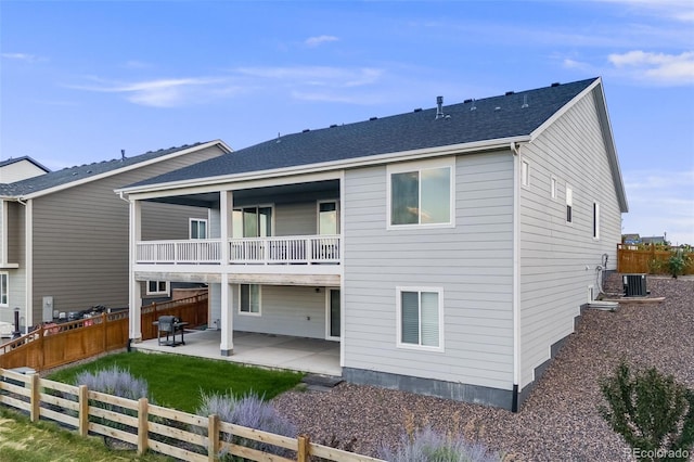 5651 Gore Creek Pl, Brighton, CO 80601 - rear view of house with a balcony, a patio, and a fenced backyard