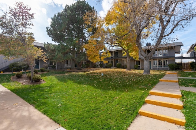 view of front of property with a front yard and a deck