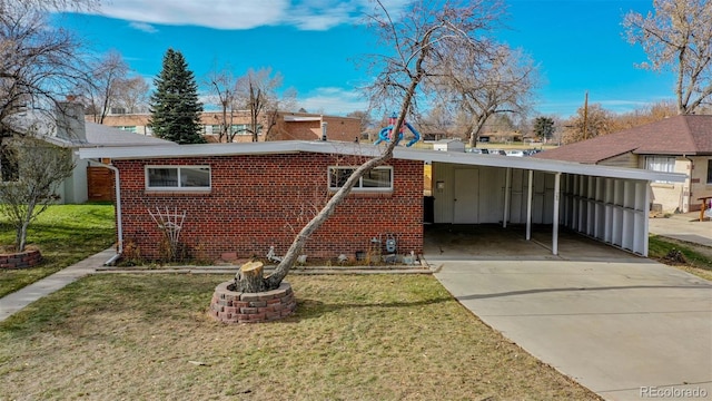 view of front of property with a front lawn and a carport