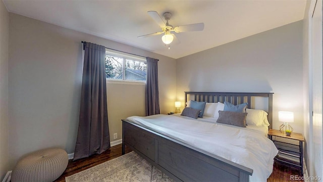 bedroom with ceiling fan and dark hardwood / wood-style floors