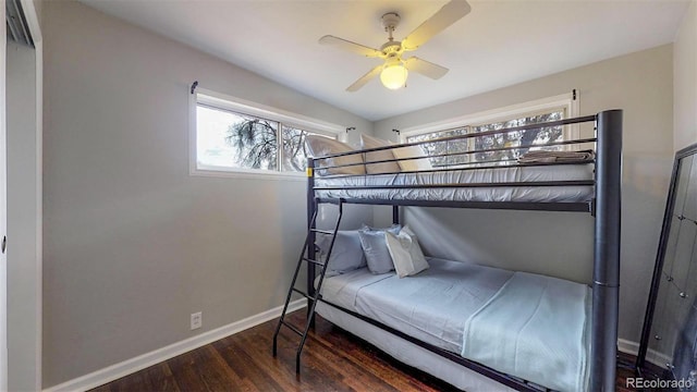 bedroom with ceiling fan and dark hardwood / wood-style floors