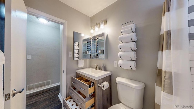 28 W Broadmoor Dr, Littleton, CO 80120 - full bathroom featuring toilet, baseboards, visible vents, wood finished floors, and curtained shower
