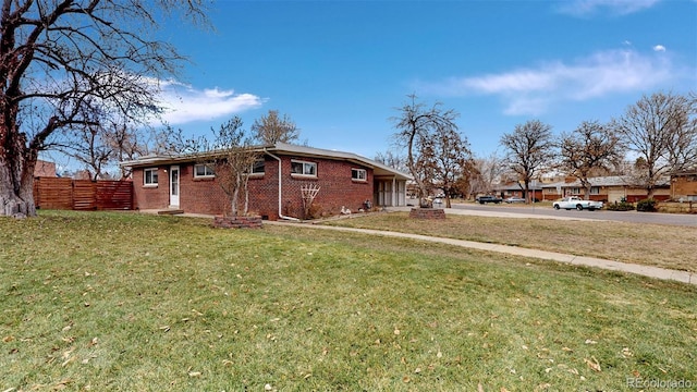 28 W Broadmoor Dr, Littleton, CO 80120 - exterior space with fence, brick siding, a yard, and concrete driveway