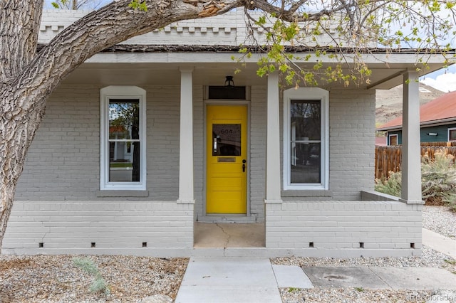 604 W 1st St, Salida, CO 81201 - view of exterior entry with crawl space, brick siding, and covered porch