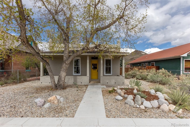 604 W 1st St, Salida, CO 81201 - view of front of home with brick siding, fence, and a porch
