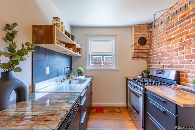 604 W 1st St, Salida, CO 81201 - kitchen featuring stainless steel gas range, wooden counters, light wood-type flooring, open shelves, and dishwashing machine