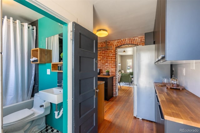 604 W 1st St, Salida, CO 81201 - kitchen featuring wood counters, dark wood-style flooring, and brick wall
