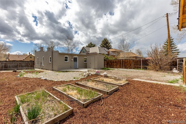 604 W 1st St, Salida, CO 81201 - fenced backyard with a vegetable garden, a storage unit, and an outbuilding
