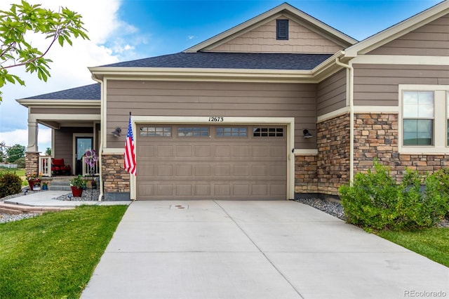12673 Tamarac St, Thornton, CO 80602 - craftsman inspired home featuring a garage, stone siding, driveway, and a shingled roof