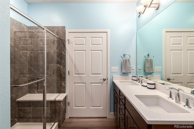 12673 Tamarac St, Thornton, CO 80602 - bathroom featuring double vanity, a stall shower, and wood finished floors