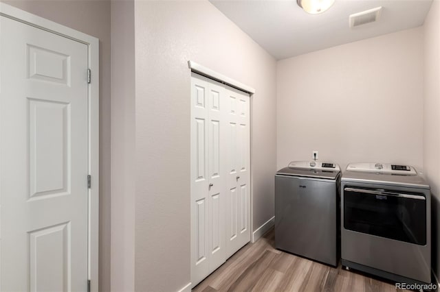 12673 Tamarac St, Thornton, CO 80602 - washroom with washer and dryer and light wood finished floors