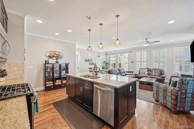 7902 E 49th Pl, Denver, CO 80238 - kitchen featuring stainless steel appliances, wood finished floors, a ceiling fan, recessed lighting, and crown molding