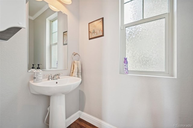 7902 E 49th Pl, Denver, CO 80238 - bathroom featuring wood finished floors and crown molding