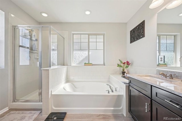 7902 E 49th Pl, Denver, CO 80238 - bathroom with vanity, a bath, and a stall shower
