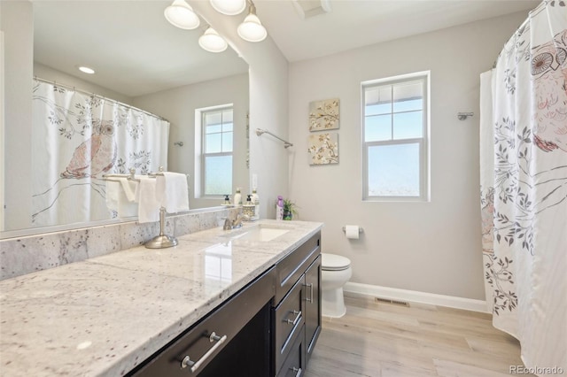 7902 E 49th Pl, Denver, CO 80238 - full bathroom with vanity, wood finished floors, and a shower with shower curtain