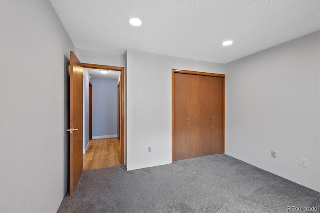 8378 S Upham Way Unit B205, Littleton, CO 80128 - unfurnished bedroom with carpet flooring, recessed lighting, a closet, and a textured ceiling
