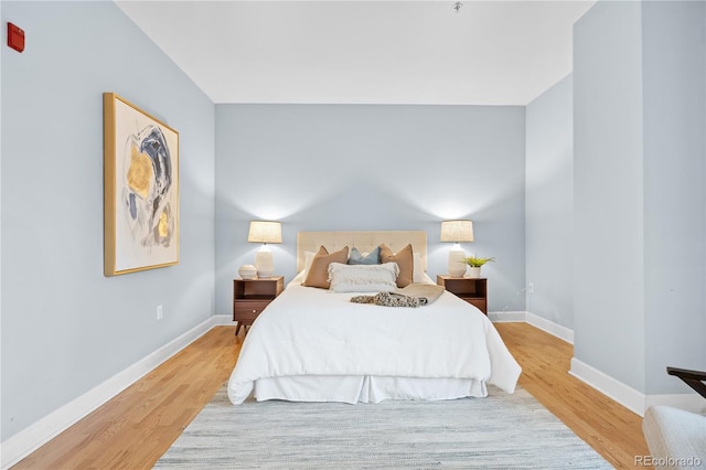 bedroom with baseboards and wood finished floors