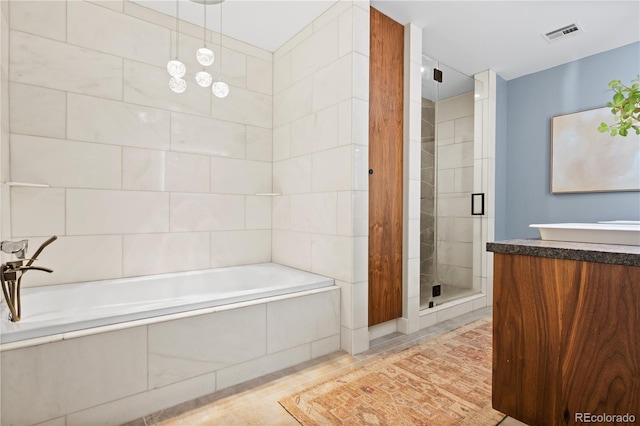 full bath featuring visible vents, a shower stall, vanity, a bath, and tile walls